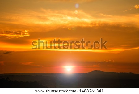 Scene of beautiful twilight sunset and mountain hill silhouette, wide cloudy golden sky. Begin of new morning day light. Natural peaceful landscape background. National park scenic, travel destination