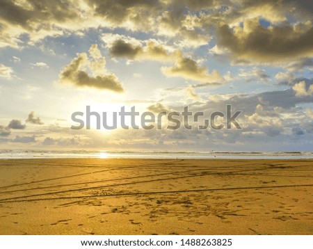 Stunning and beautiful sunset time over the Pacific Ocean. Massive beach and colourful sky background photo.
