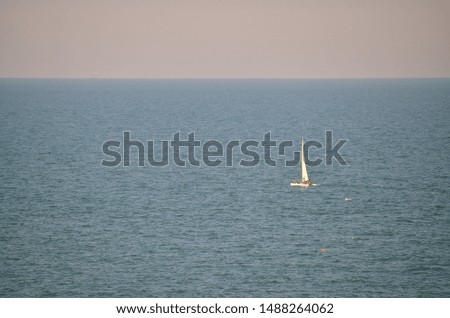 Lonely sailboat over the sea. Free space for copy text banner