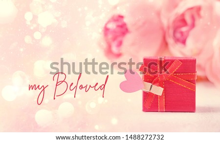 My Beloved - greeting card. flowers and gift box with heart on abstract pink background. romantic present for Valentine's day, 14 february holiday. Mother's day, birthday concept. festive card design