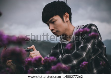 Asian Thai man portrait in Lavender flower field on a mountain background at Mon Jam, Chiang mai Thailand. Vintage style.