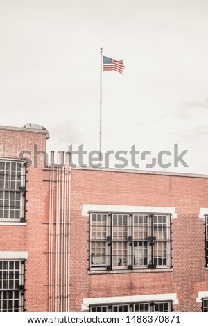 flag of the united states above a school