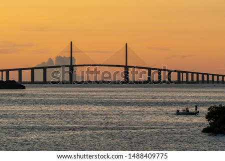 Tampa Bay, Florida and bridge at dawn with an orange sky
