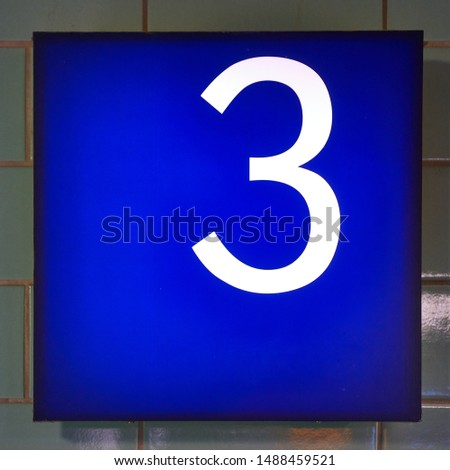 Number 3 in white on a blue background.