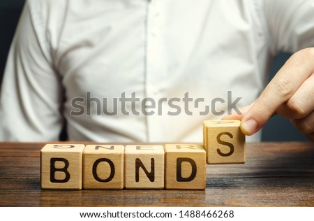 Businessman puts wooden blocks with the word Bonds. A bond is a security that indicates that the investor has provided a loan to the issuer. Equivalent loan. Unsecured and secured bonds. Royalty-Free Stock Photo #1488466268