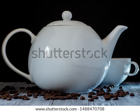 Coffee cup and coffee beans on the wooden table