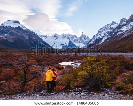 Laguna Torre hiking trek with backpacker couple looking at view of snowcapped peaks of Cerro Torre. DRONE SHOT. Mountains, nature, travel. Shot in El Chalten, Mount Fitzroy, Patagonia, Argentina