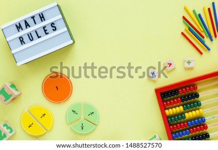 Creative Сolorful light box, fractions on yellow background. Interesting funny math for kids. Education, back to school concept. Geometry and mathematics materials. Flat lay, top view	