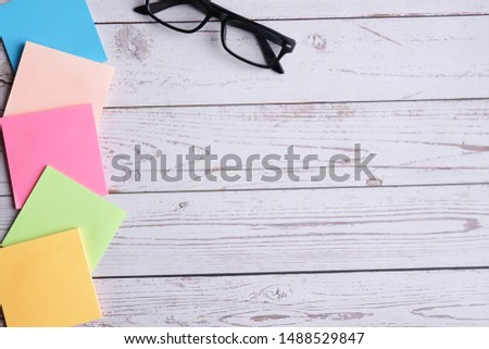 Colorful sticky note and glasses. 