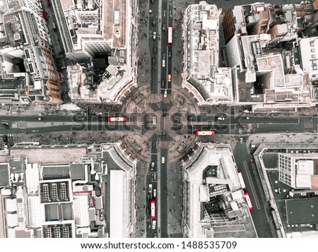 Drone shot of Oxford Circus during the day, with cars and red buses