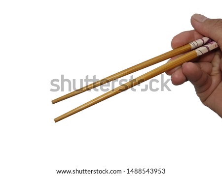 hand holding chopsticks on white background.
