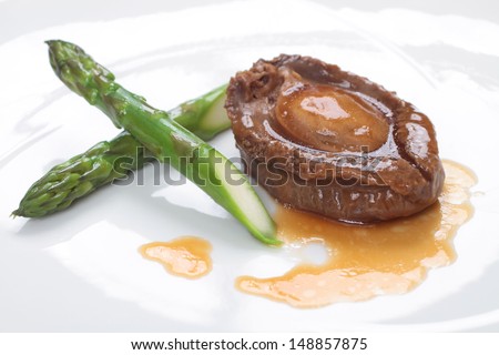 Whole abalone and asparagus