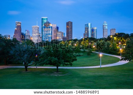 High quality image of night Downtown Houston skyline in Houston, Texas USA at twilight. May use as banner or header of website. Downtown is a bustling business hub and home to major attractions.