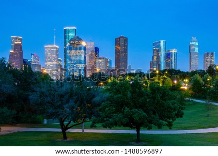 High quality image of night Downtown Houston skyline in Houston, Texas USA at twilight. May use as banner or header of website. Downtown is a bustling business hub and home to major attractions.