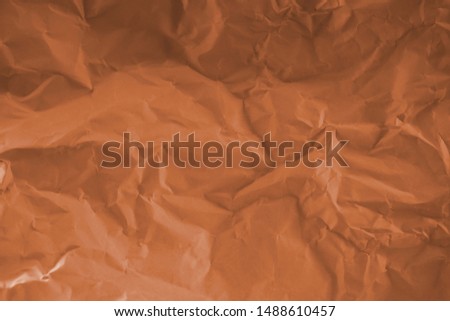Wrinkled orange paper fragment as a background texture.