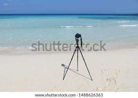 tripod and camera on the beach              