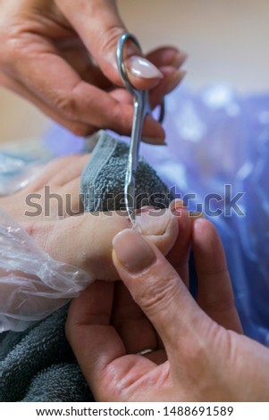 Pedicure treatment in beauty salon. Close up concept. Process of pedicure at beauty salon. vertical photo