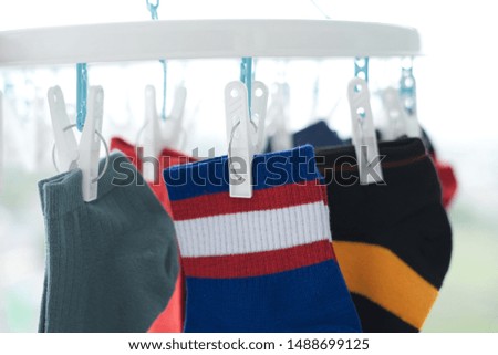 Clothes peg clamping socks being dried