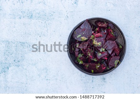 Sweet beetroot salad. Cooked with olive oil, vinegar, pumpkin and sesame seeds , herbs in bowl. Close up.