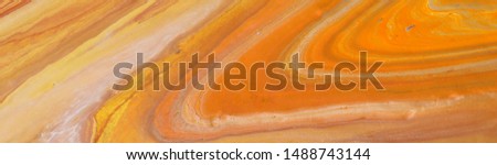photography of abstract marbleized effect background. orange, gold, yellow and white creative colors. Beautiful paint. banner