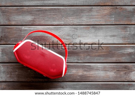 Wireless speaker as music gadgets on wooden background top view mock up