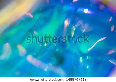 Holographic iridescent surface. Colorful hologram background. Abstract texture with multiple colors. Neon surface. Copy space. 