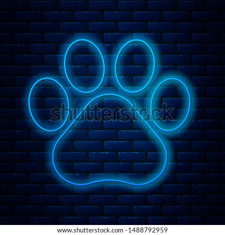 Glowing neon line Paw print icon isolated on brick wall background. Dog or cat paw print. Animal track.  Vector Illustration