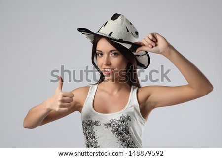 girl cowboy showing okay sign isolated on a white background