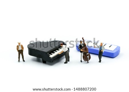 Miniature people : pianist playing piano and Violinist Man,playing musical instrument concept.
