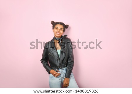 Beautiful young African-American woman on color background