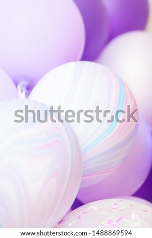 Vertical close up banner of purple and violet balloons as a background. Birthday background with ballons.