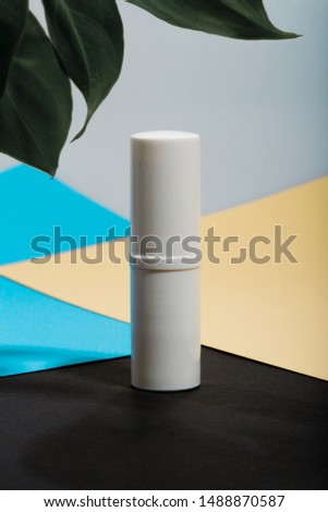 Lip balm packaging white lip balm, packaging mockup with green leaves on a colorful background