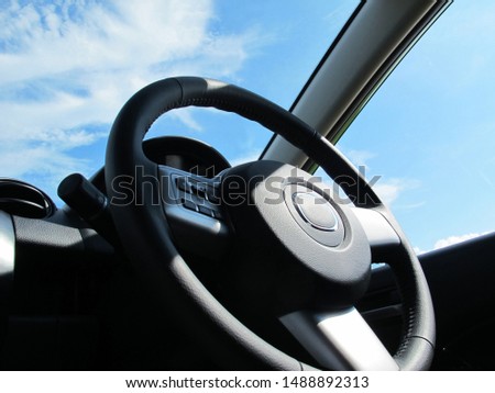 Car steering wheel, view from inside the car.