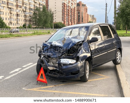 Car crash collision on the city street. Car bonnet, headlights, front bumper, engine has severe damage after an accident. Carelessness on the road