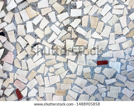 Part of the wall is decorated with a small light mosaic tile. Can be used as background, texture and in the interior.