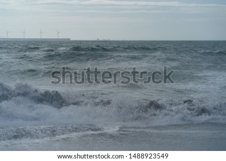 Lifestyles near Atlantic ocean. The shore with eco friendly turbines in Biscay Bay in summer day. Natural background, suitable for banner, postcard, greeting card, poster. High resolution photography.