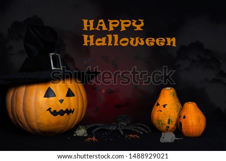 Halloween background with the lettering "Happy Halloween ". A pumpkin in a black hat. Pumpkins, mice, spiders, toad against a dark background.