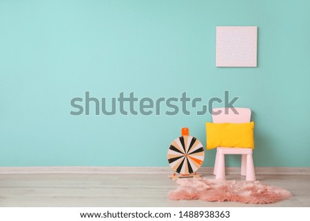 Chair with play wheel near color wall in children's room