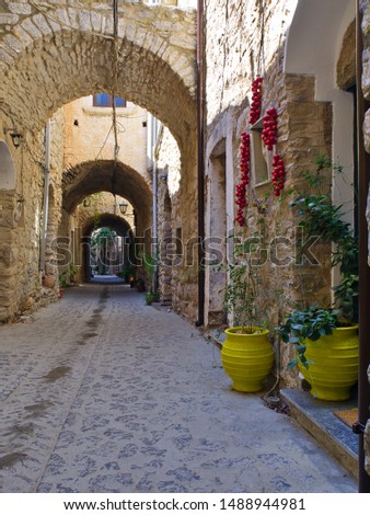 Narrow alley in medieval village of Mesta in Chios island, Greece. Traditional stone fortified village.