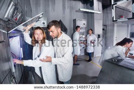 Group of adults trying to get out of the escape room stylized under a laboratory 