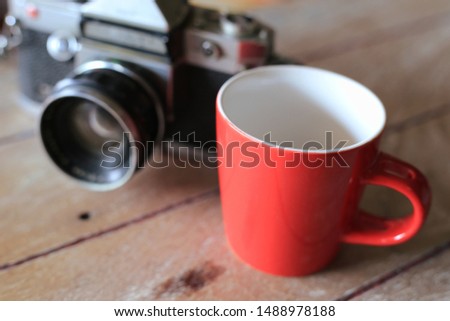 Close-up of a red coffee cup on an old wooden floor selective focus and shallow depth of field