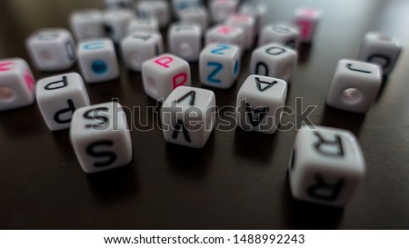 Mixed letters in dice form.                            