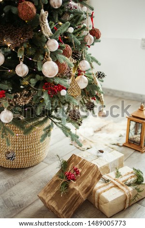 Beautiful craft christmas boxes under the christmas tree.
