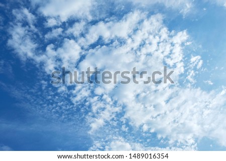 One Find Day, fluffy clouds on blue sky.