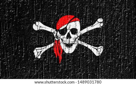 Flag of pirate close up painted on a cracked wall