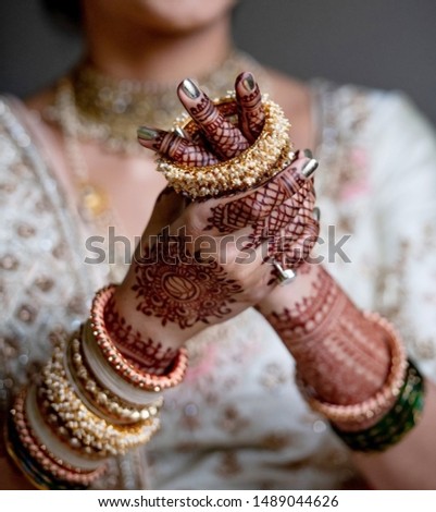 Pakistan Indian Bride wearing Gold bangles jewelry Royalty-Free Stock Photo #1489044626