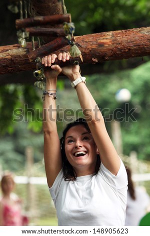 Happy woman climbing, outside