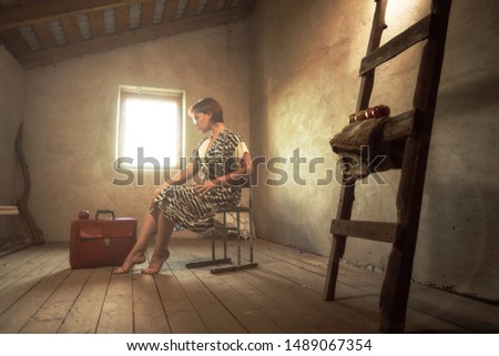 a girl on the attic with few apples and suitcase / expectation