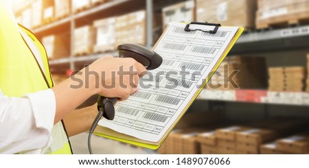 Worker checking and scanning package by laser barcode scanner in modern warehouse. Royalty-Free Stock Photo #1489076066