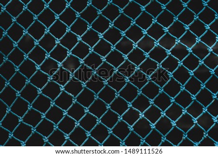 Dark green rope mesh background in dark tones